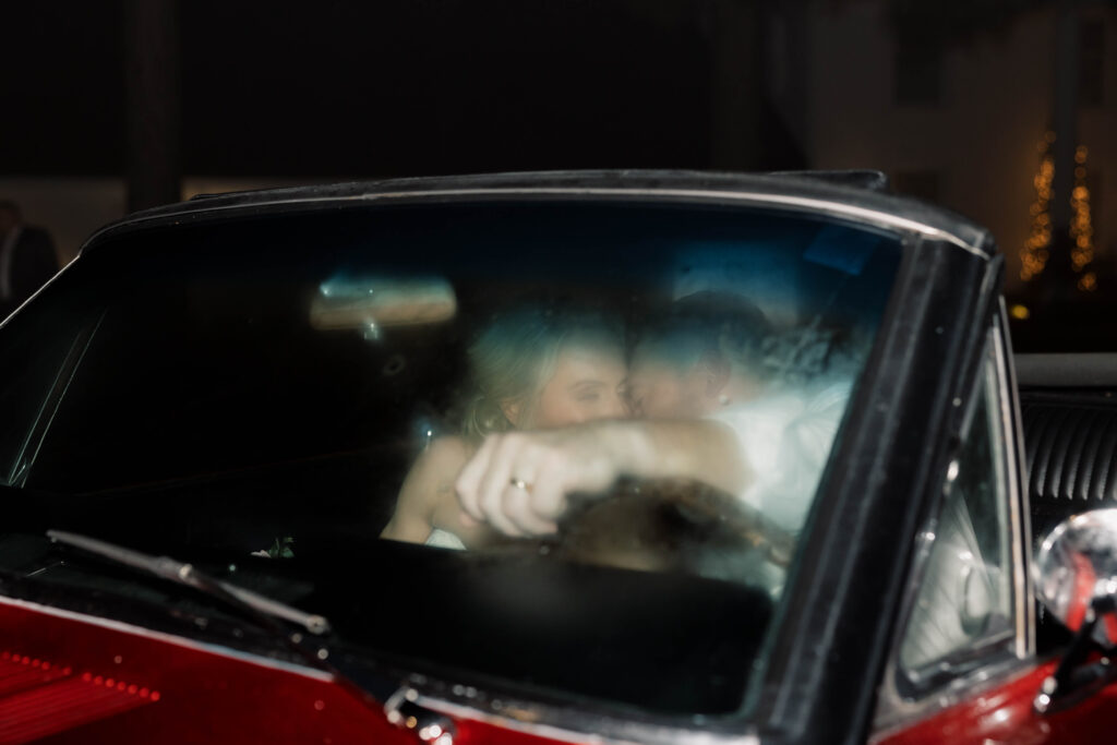 heron hill wedding | bride and groom kissing in classic car 