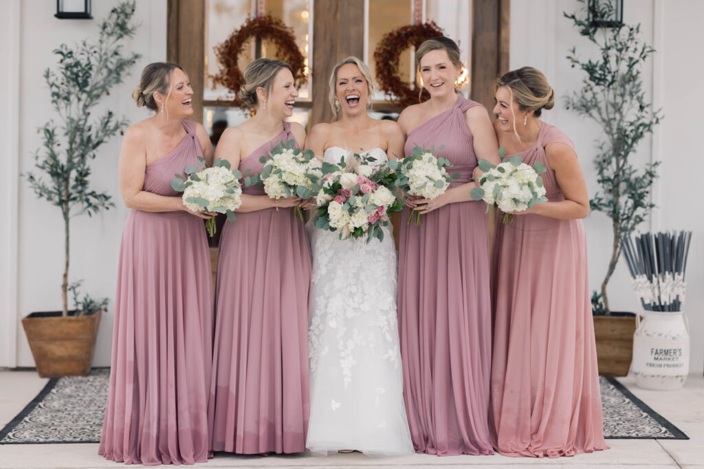 heron hill wedding | bridal party laughing with bouquets