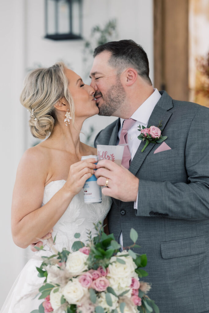 heron hill wedding | Bride and groom kissing and cheers