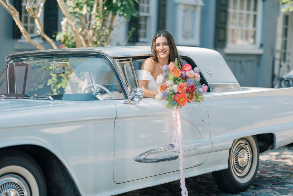 Charleston sc wedding photographer | Bride on chalmers street in a classic blue thunderbird (birdie)