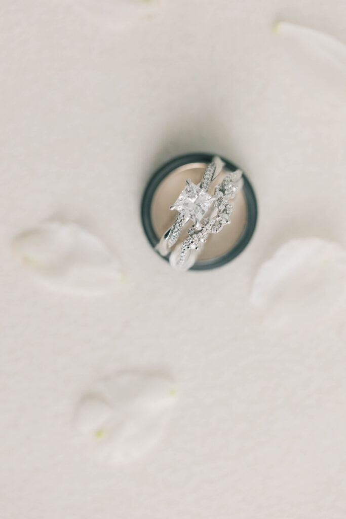 light and airy wedding photography | wedding bands with flower petals