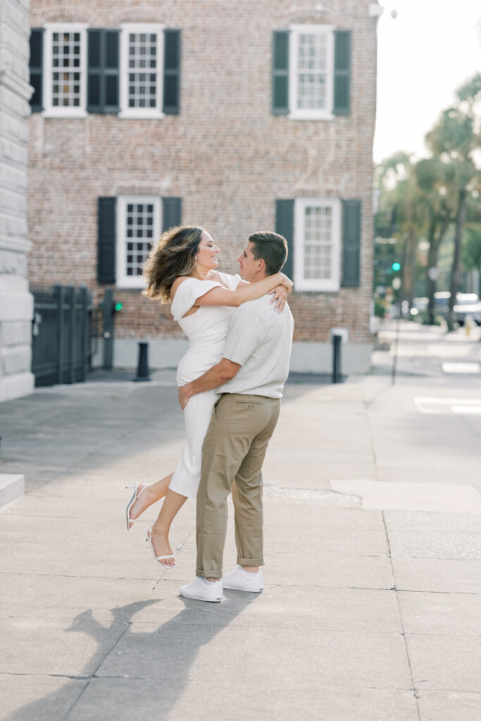 Engagement Photo Ideas in Charleston SC couple in love by charleston courthouse