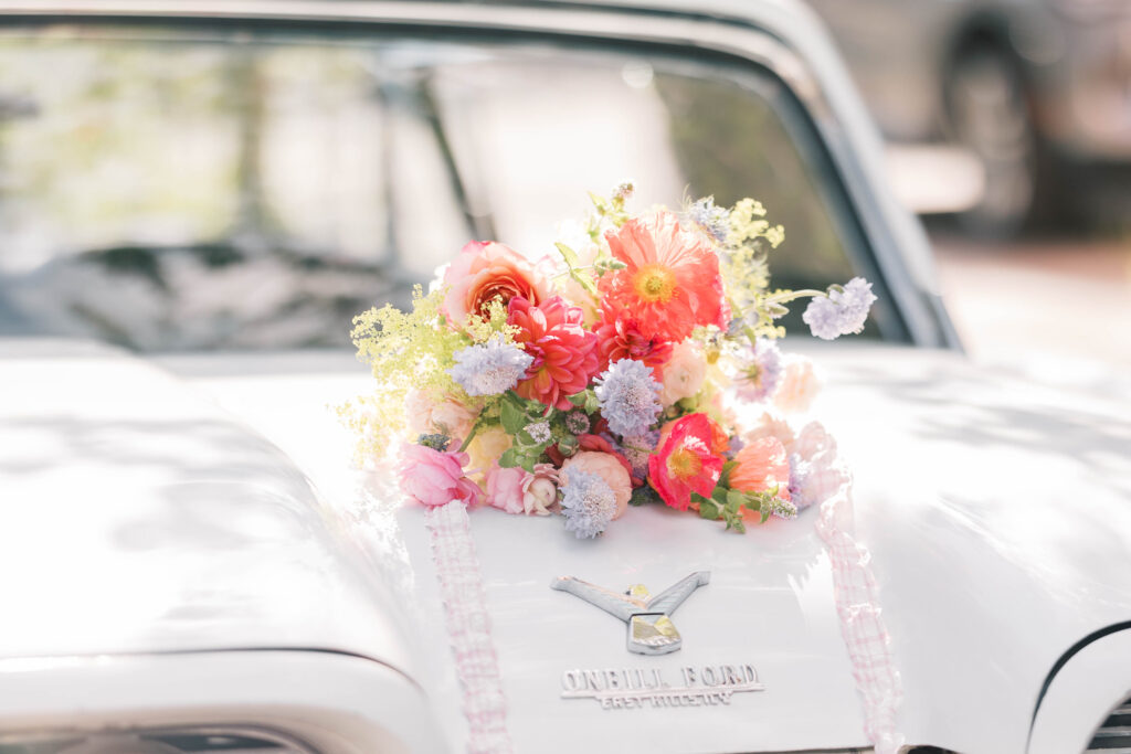 light and airy wedding photography | florals on antique car