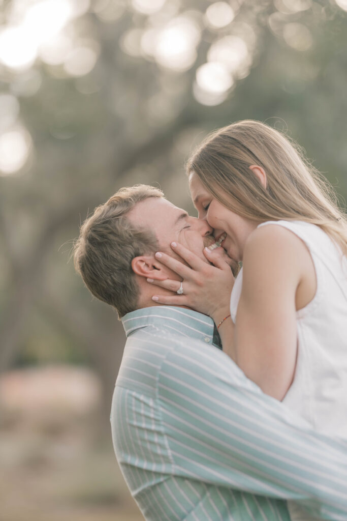 Engagement Photo Ideas in Charleston SC couple smiling and kissing at magnolia place