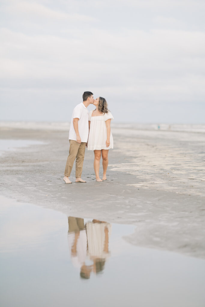 Wedding photographer south carolina  | Couple holding hand and kissing with reflection at beach