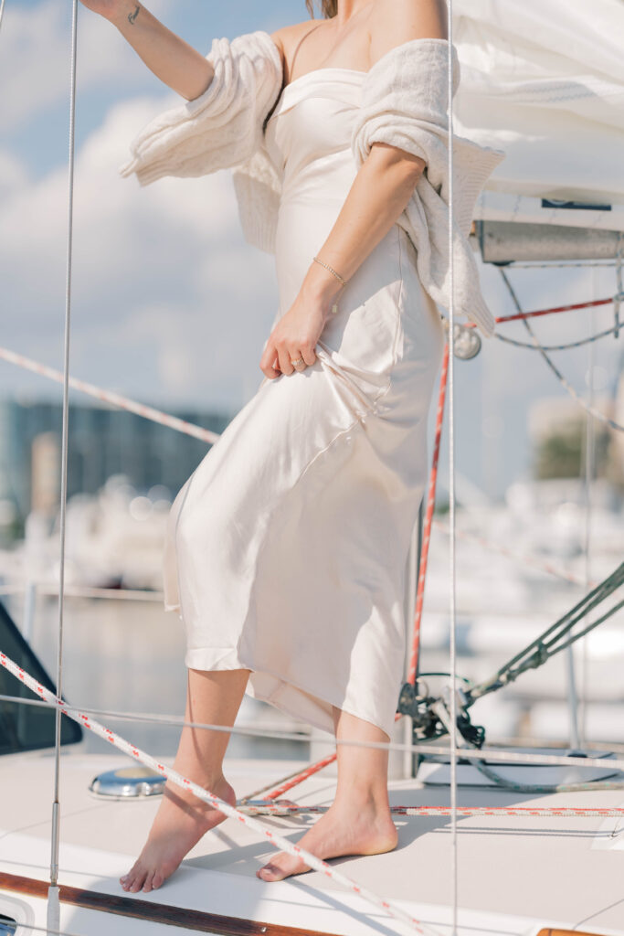 luxury wedding ideas | Bride on a sailboat in charleston with the wind blowing