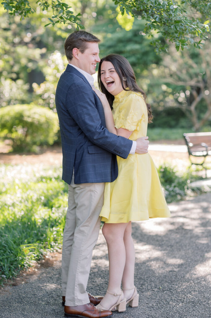 Engagement photographer near me | couple laughing together at the  south carolina state house grounds