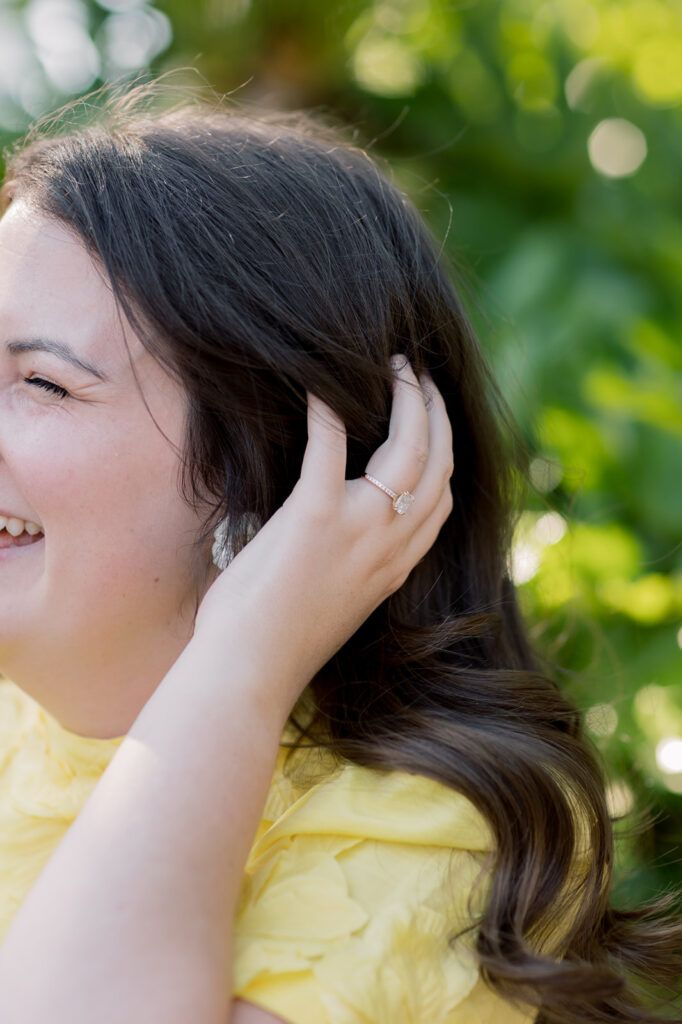 Engagement photos near me | girl running hands through hair with engagement ring