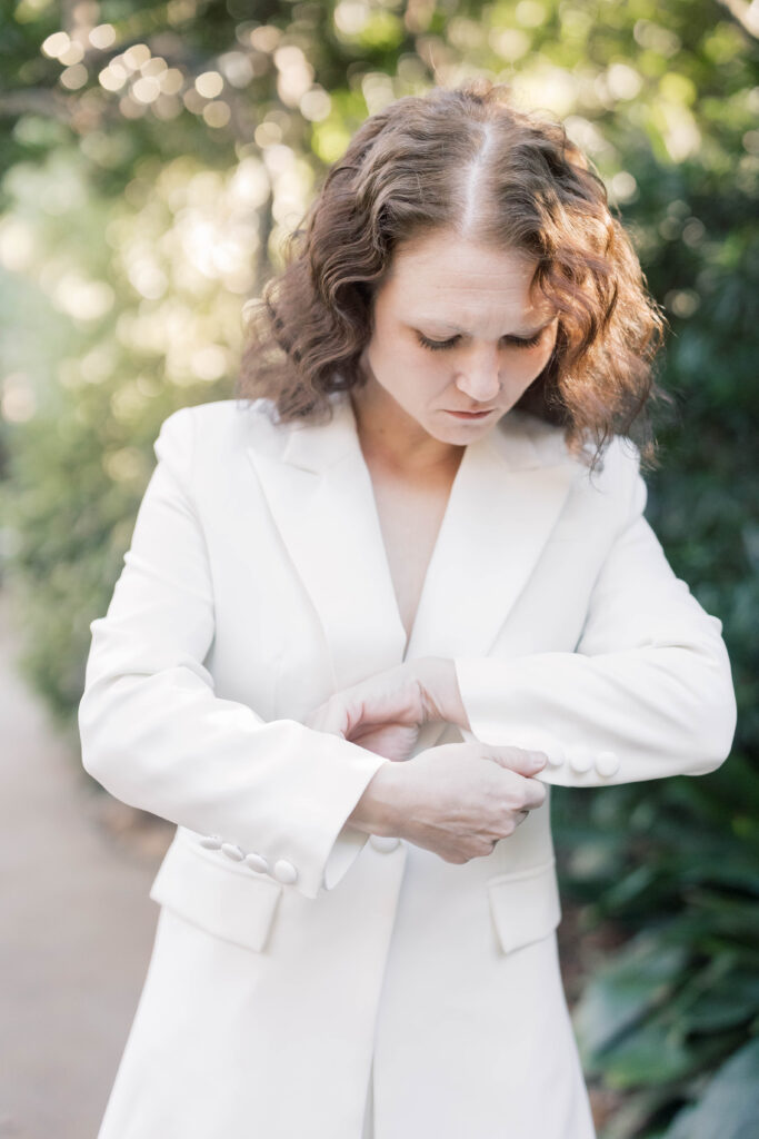 south carolina photographer | bride buttoning white suit