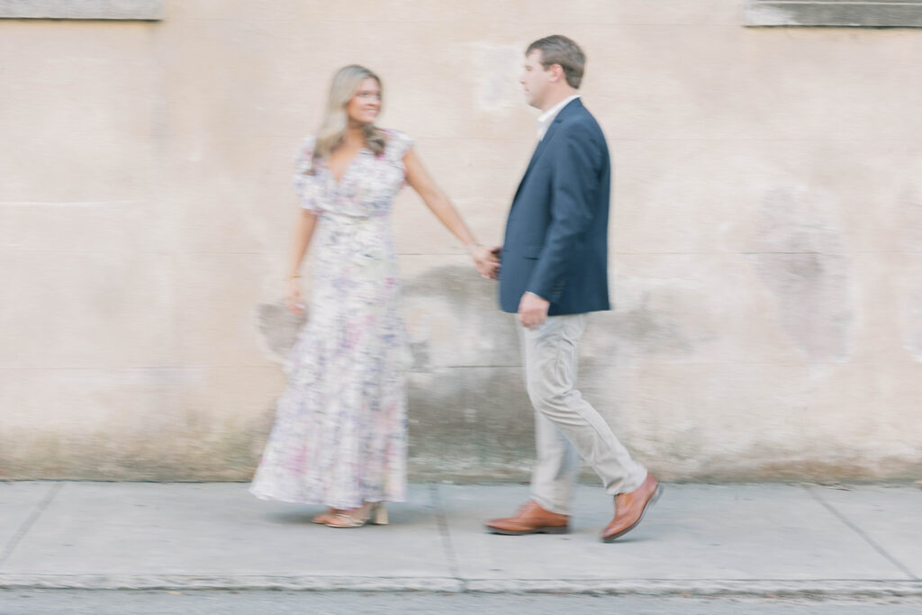 Engagement photos near me | couple walking down charleston street holding hands