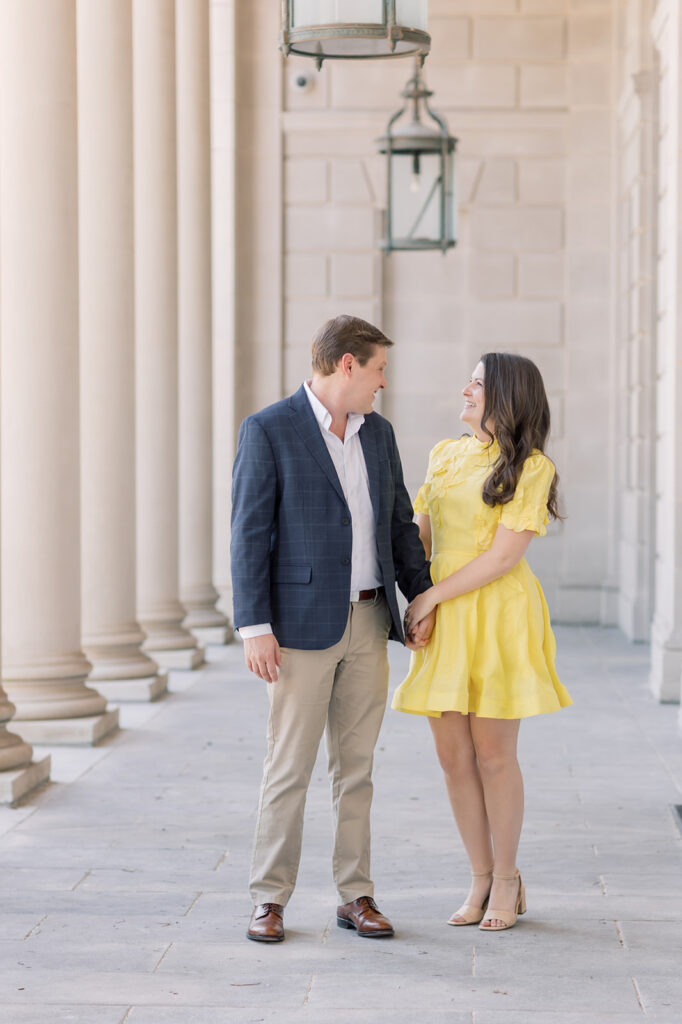 Engagement photographer near me | couple looking at each other at the sc statehouse