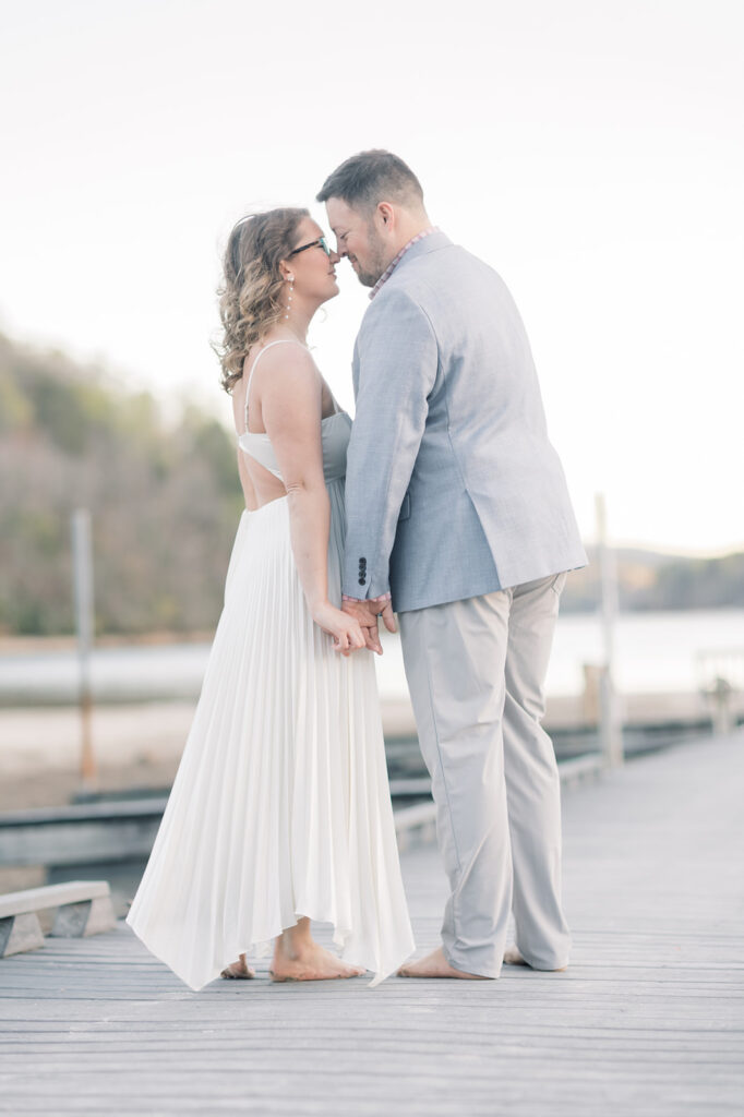 Engagement photographer near me | Couple about to kiss on dock in lake lure