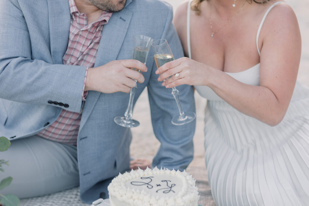 Engagement photographer near me | Couple holding glasses of champagne