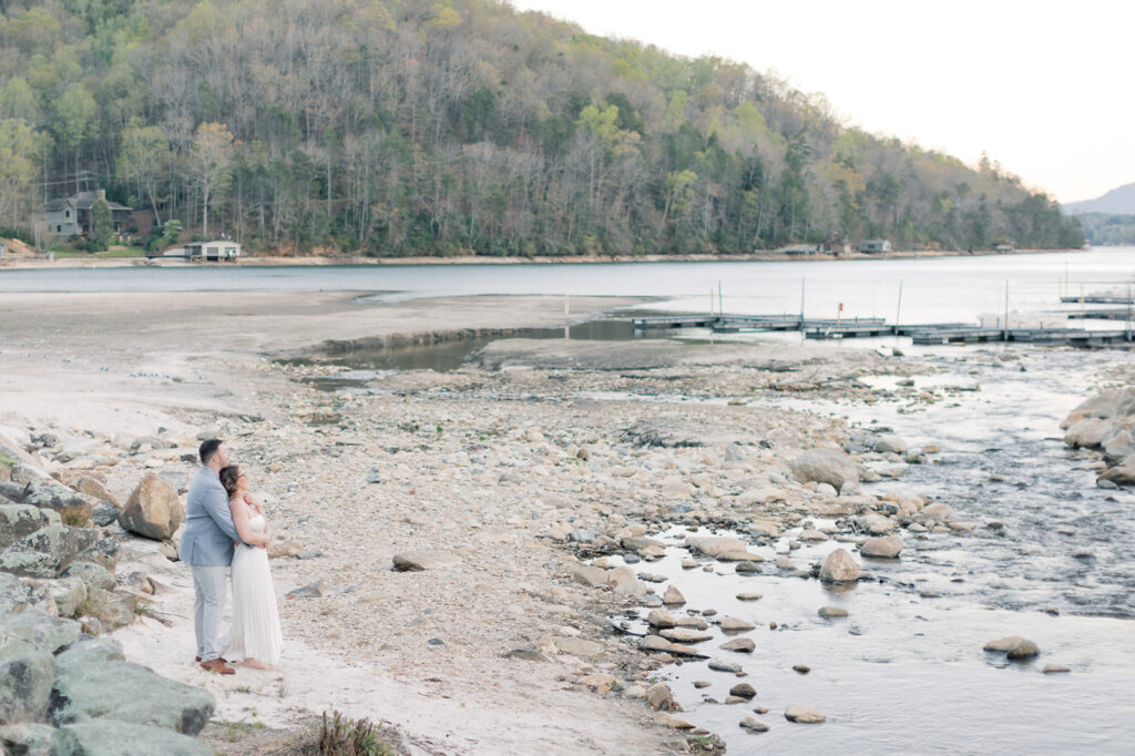 Engagement photographer near me | Couple looking out over lake lure 