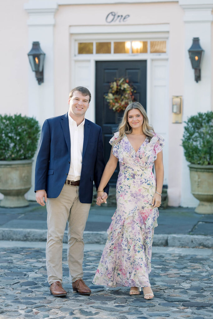 Charleston SC engagement photos | couple holding hands walking on cobblestone street