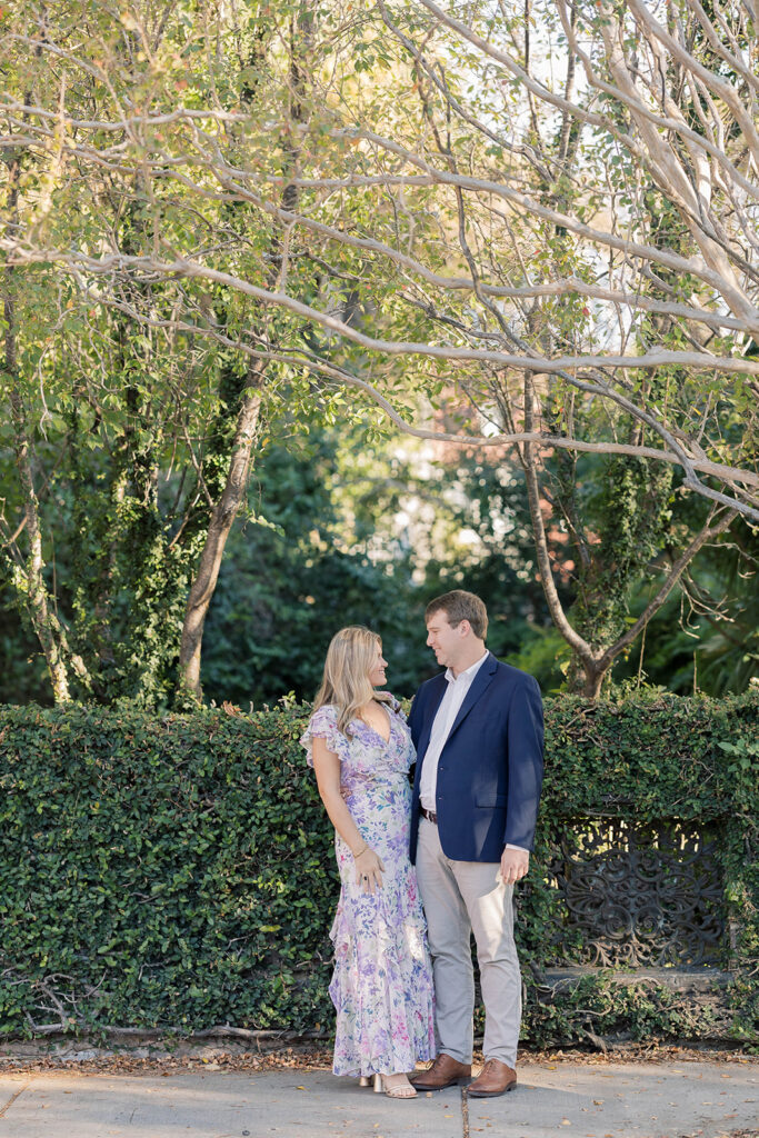 Charleston SC engagement photos | coule standing on the sidewalk of charleston