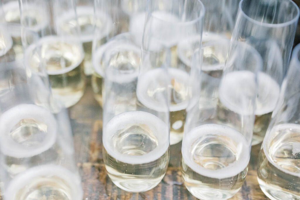 south carolina photographer | champagne in glasses at wedding at river road jasmine house