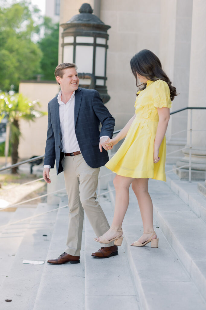 Engagement photographer near me | couple walking down the stairs at sc statehouse