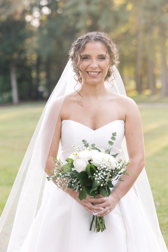  Bridal Portraits | bride holding bouquet and smiling 