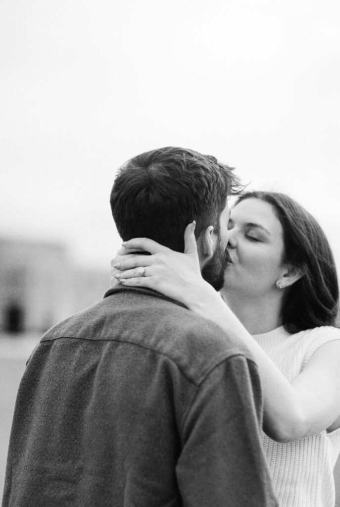 Film Photographer | Black and white 35mm film image of a couple kissing on parking garage in Columbia South Carolina.