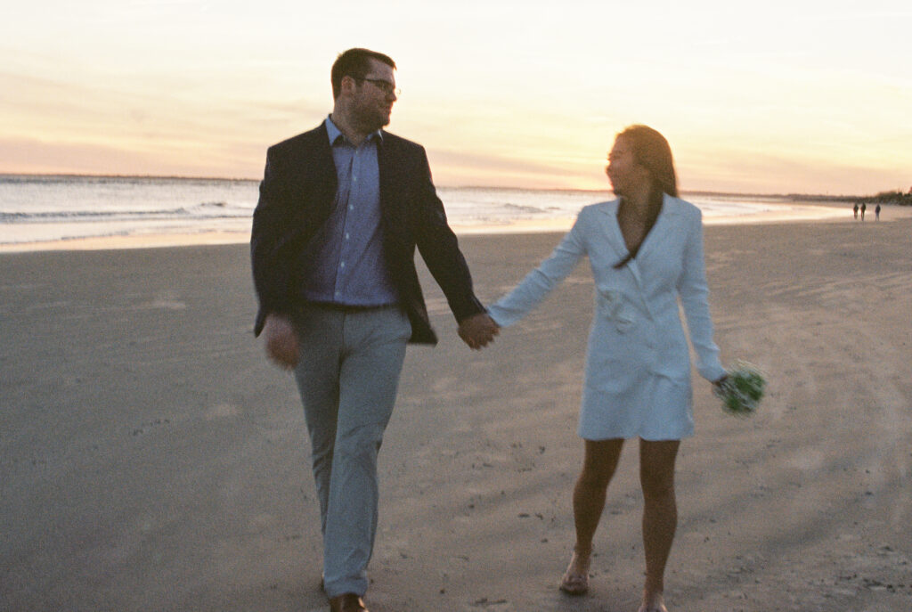 Film Photographers | Elopement filmed with 35mm film.  Wedding photographed in film. Couple holding hands walking down the beach at Sullivans Island.