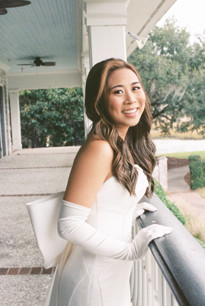 Film Photography | Bride in wedding dress on porch at Dunes West in Charleston South Carolina