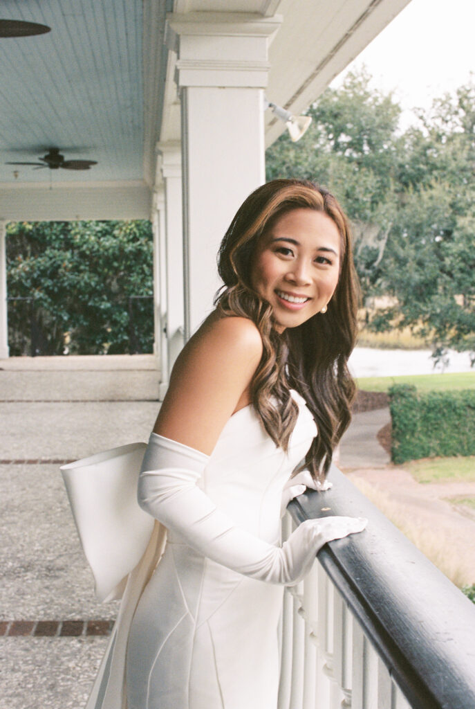 Film Photography | Bride with gloves and bow on wedding day at Dunes West Wedding Venue in Charleston SC