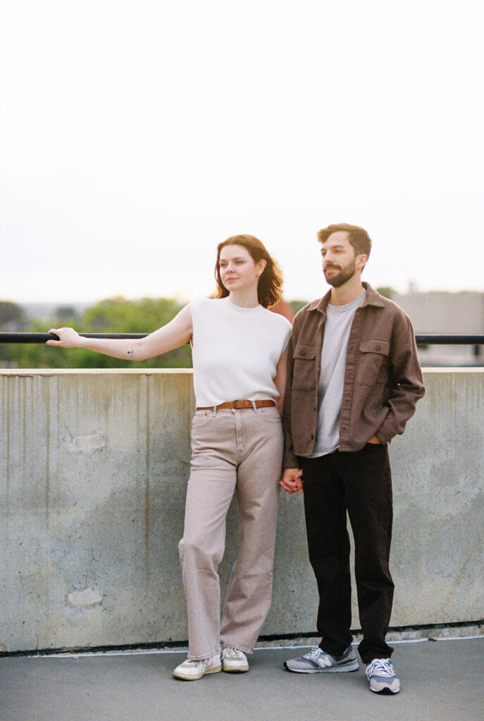 Film Photography | Beautiful couple, looking out in Charleston South Carolina. Photographed during engagement session. Photographed in 35mm color film.