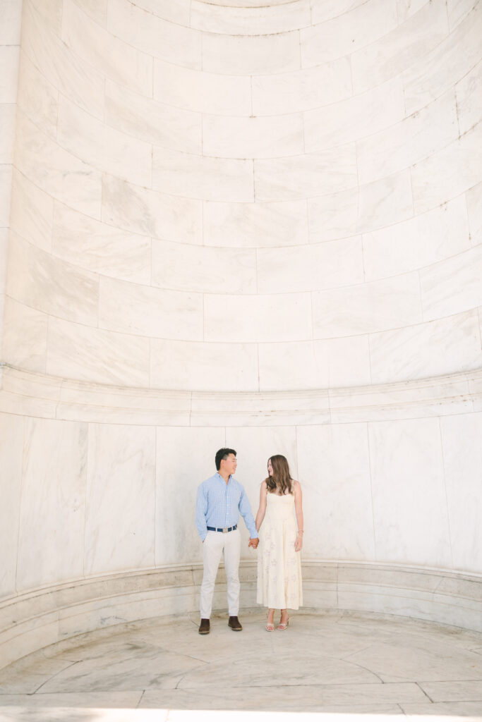 DC Engagement Photographer | Engagement session in Washington, DC | couple holding hands and looking at each other at the Thomas Jefferson Memorial