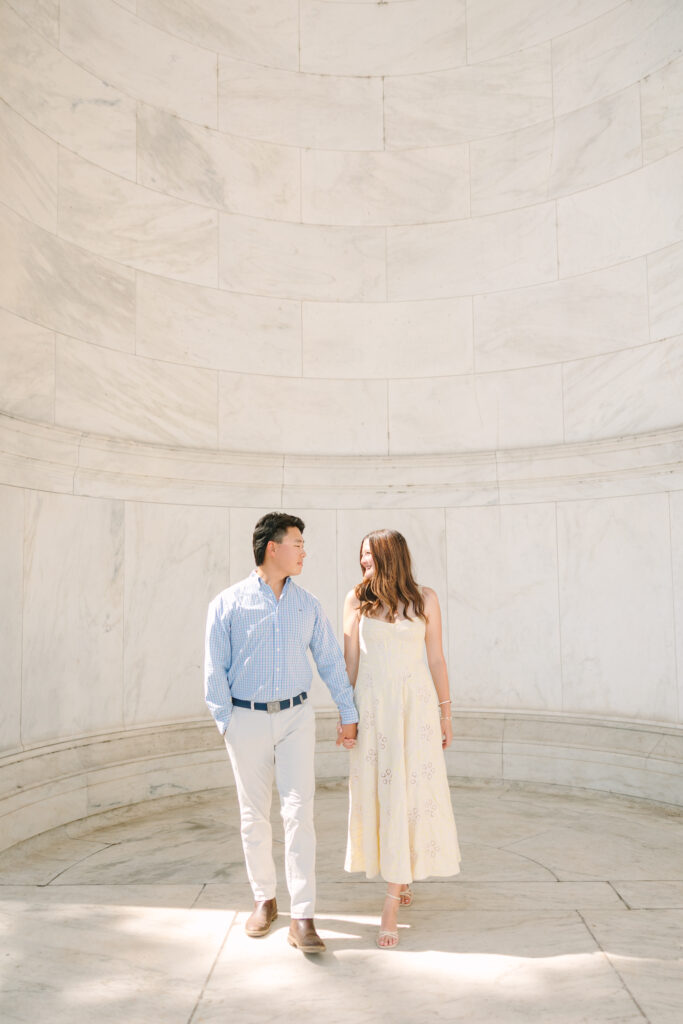 DC Engagement Photographer | Engagement session in Washington, DC | couple holding hands and walking at the Thomas Jefferson Memorial