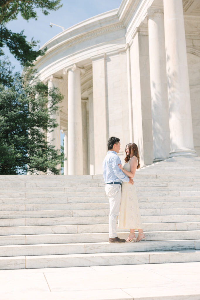 DC Engagement Photographer | Engagement session in Washington, DC | couple holding each other in front of the Thomas Jefferson Memorial