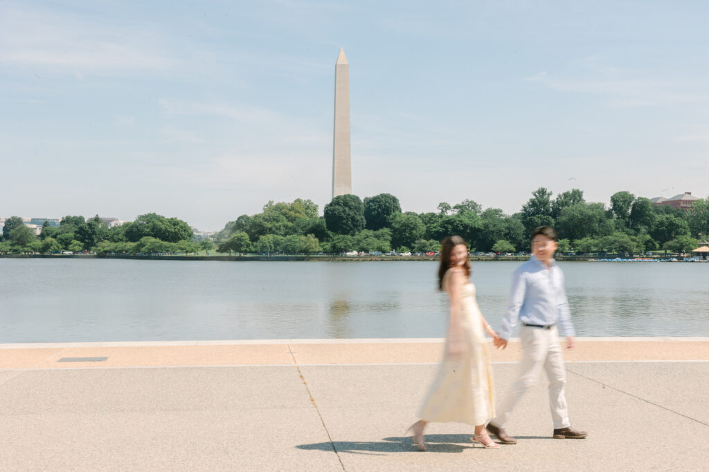DC Engagement Photographer | Engagement session in Washington, DC | Couple holding hand and walking in a motion blur photo