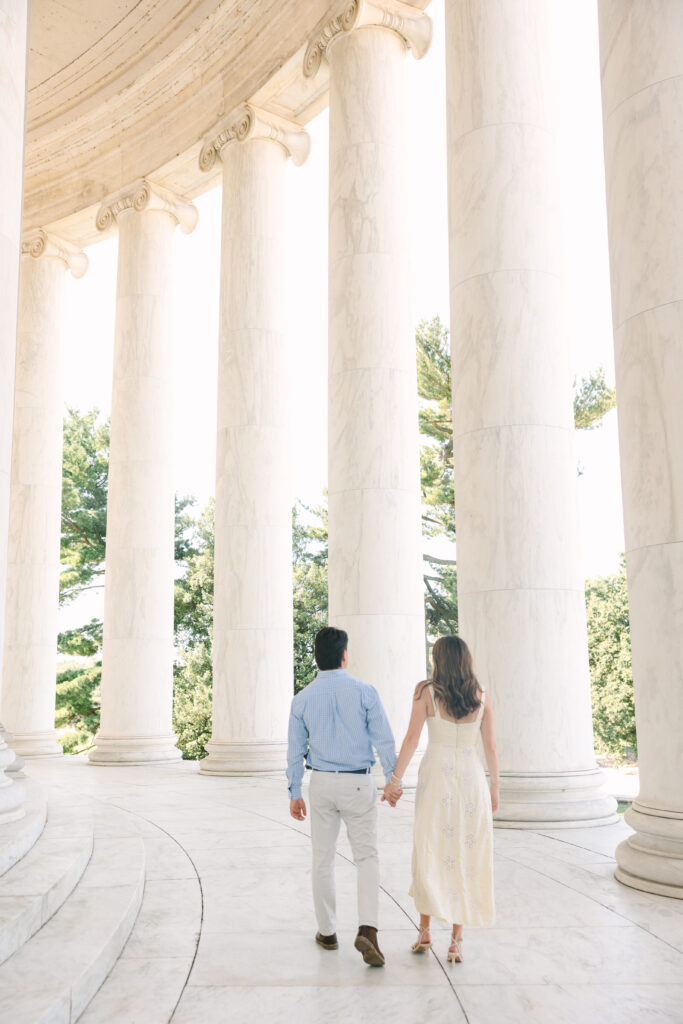 DC Engagement Photographer | Engagement session in Washington, DC | couple holding hands and walking away at the Thomas Jefferson Memorial