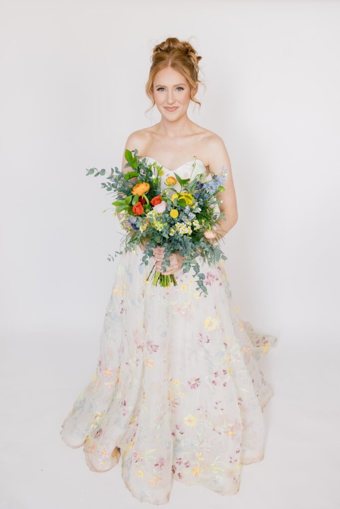 Bridal Portraits | Studio Bridal Session at 701 Whaley | Bride looking at camera holding bouquet