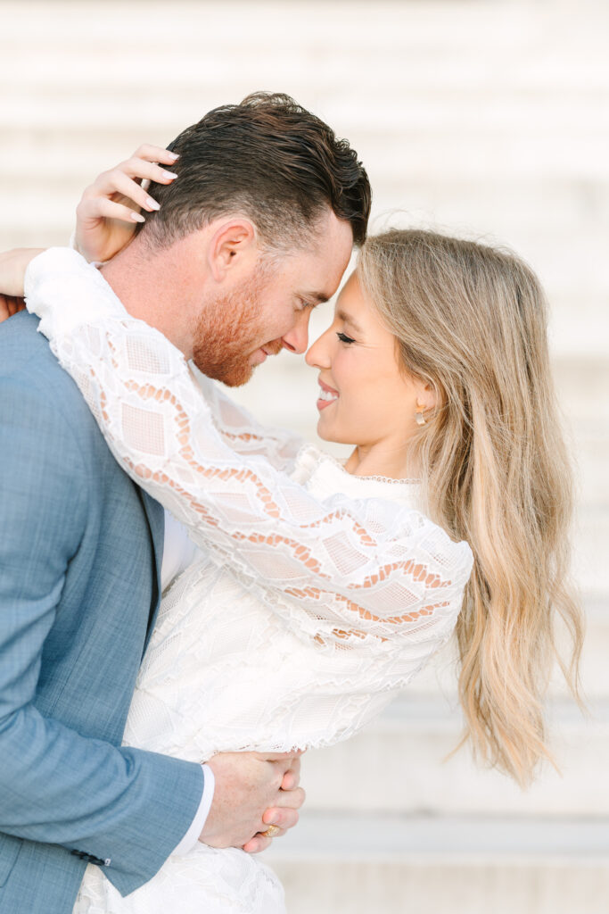 DC Engagement Photo | Couple looking at each other and smiling in front of the Lincoln Memorial Steps