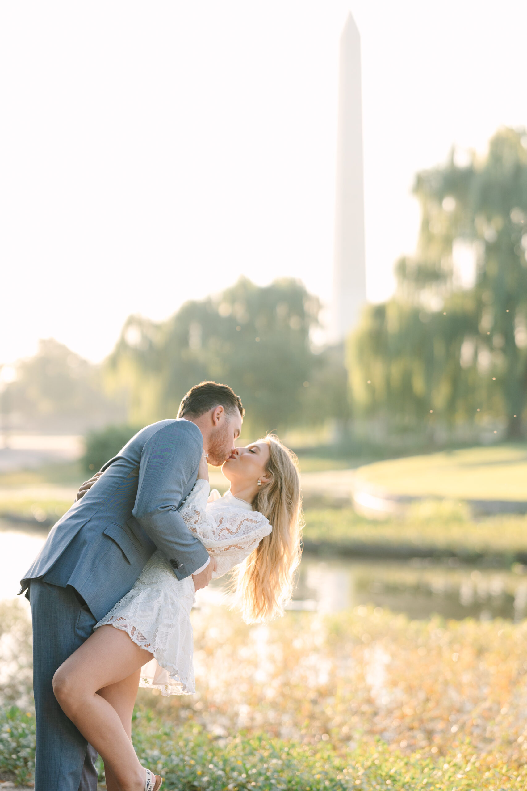 DC engagement photo of couple kissing with the Washington Monument in the background