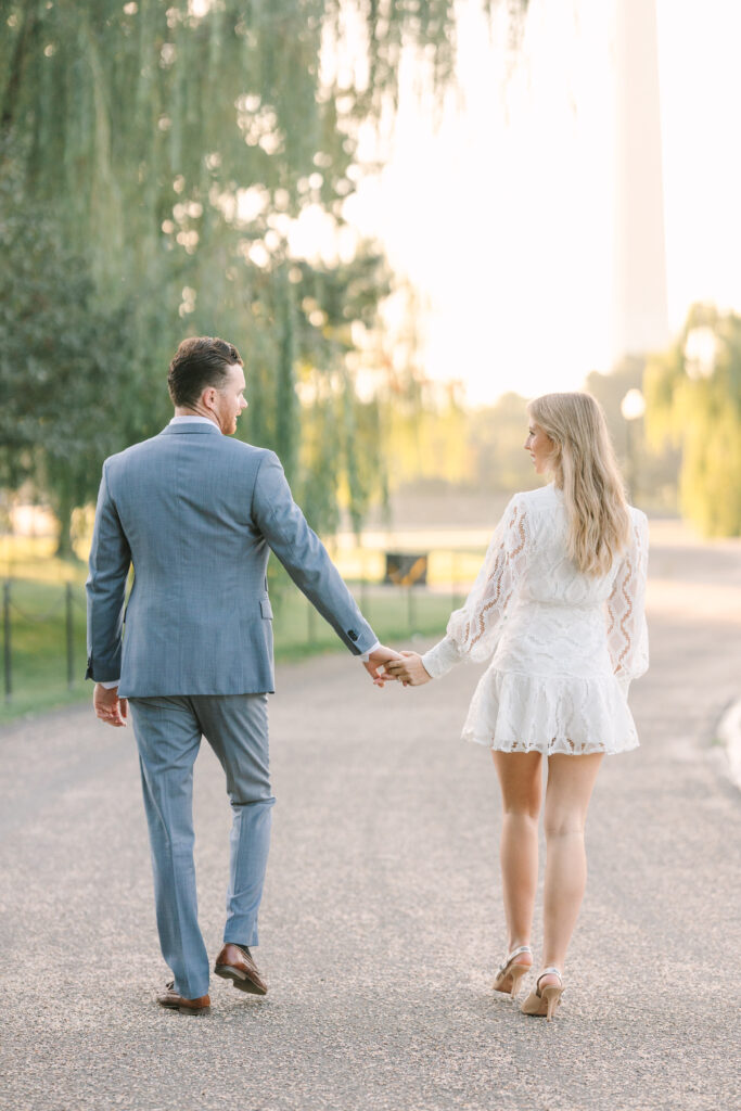 DC Engagement Photo | Couple holding hands and walking in Washington DC at Sunrise