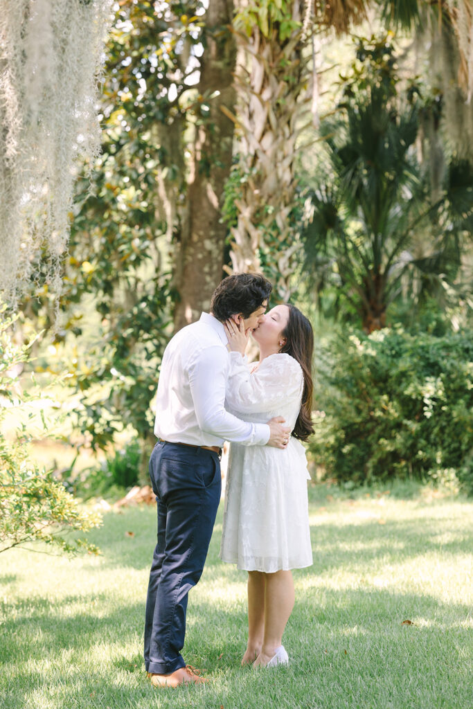 Charleston engagement photographers | Engagement session in Charleston SC | couple kissing underneath a palmetto tree