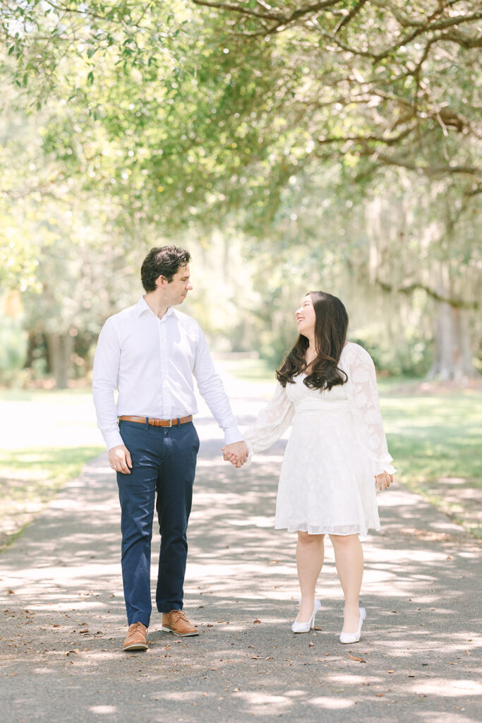Charleston engagement photographers | Engagement session in Charleston SC | Couple walking under trees