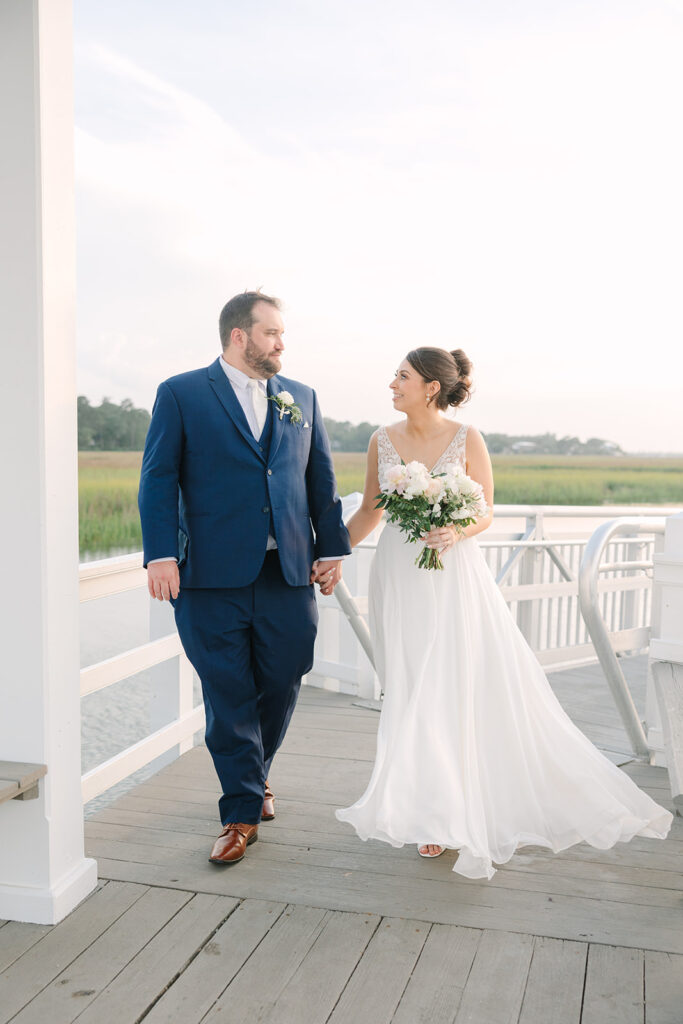 Charleston wedding Photographer | Creek at Ion Wedding | bride and groom walking on dock at sunset