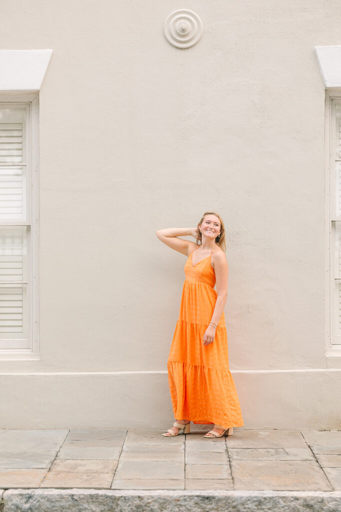 Charleston senior pictures | Senior session in Charleston SC | Senior in orange dress in front of off white wall