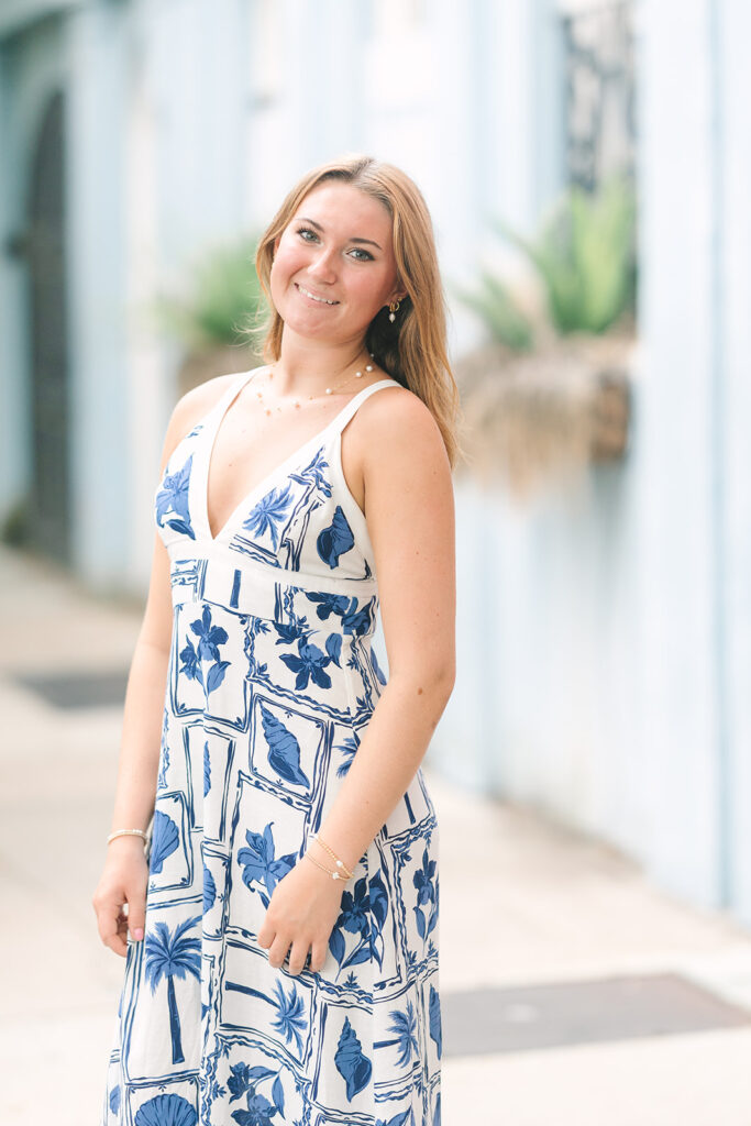 Charleston senior pictures | Senior session in Charleston SC | Senior in front of blue home at rainbow row