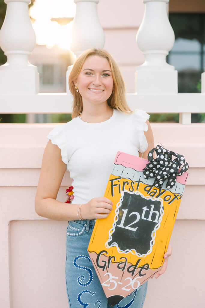 Charleston Senior Pictures | Senior Session in Charleston SC | senior at sunset holding first day of school sign