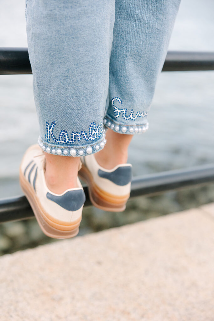 Charleston Senior Pictures | Senior Session in Charleston SC | bottom of jeans, custom made to say the seniors name while she stands on railing
