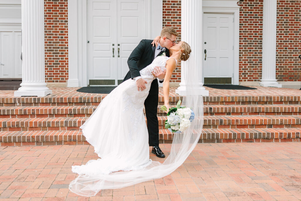 Columbia South Carolina Photographer | 701 Whaley Wedding|  bride and groom kiss in front of church