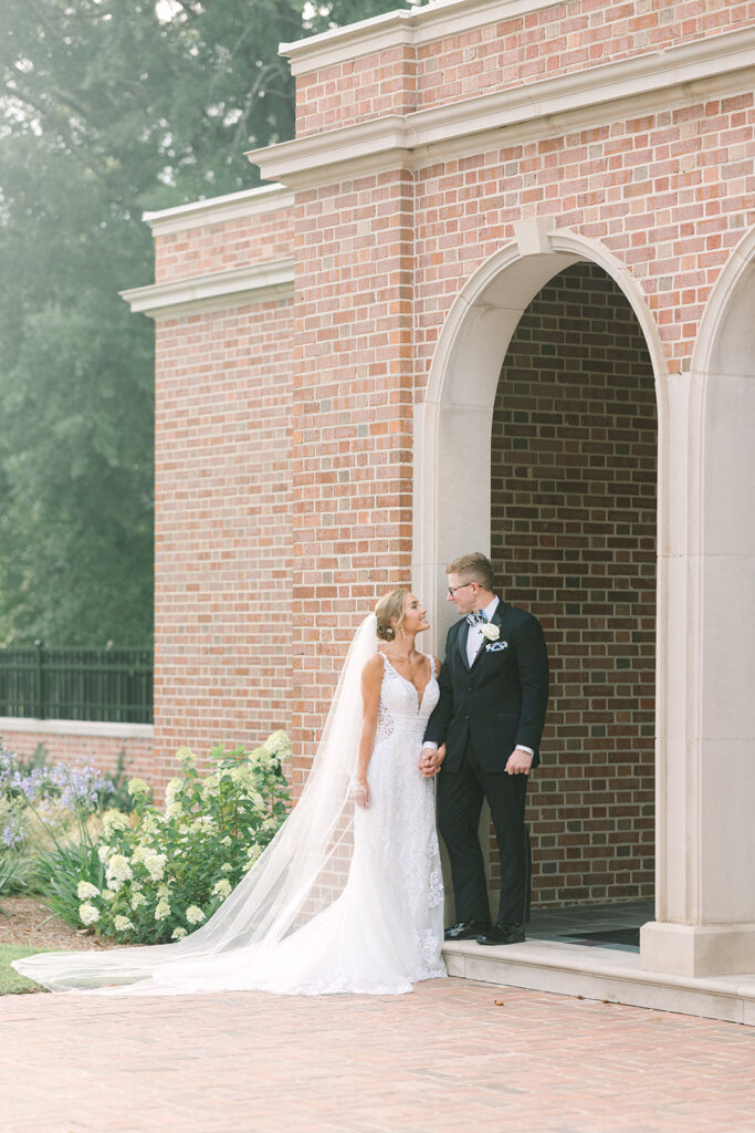 Columbia South Carolina Photographer | 701 Whaley Wedding|  bride and groom looking at each other in archway at church