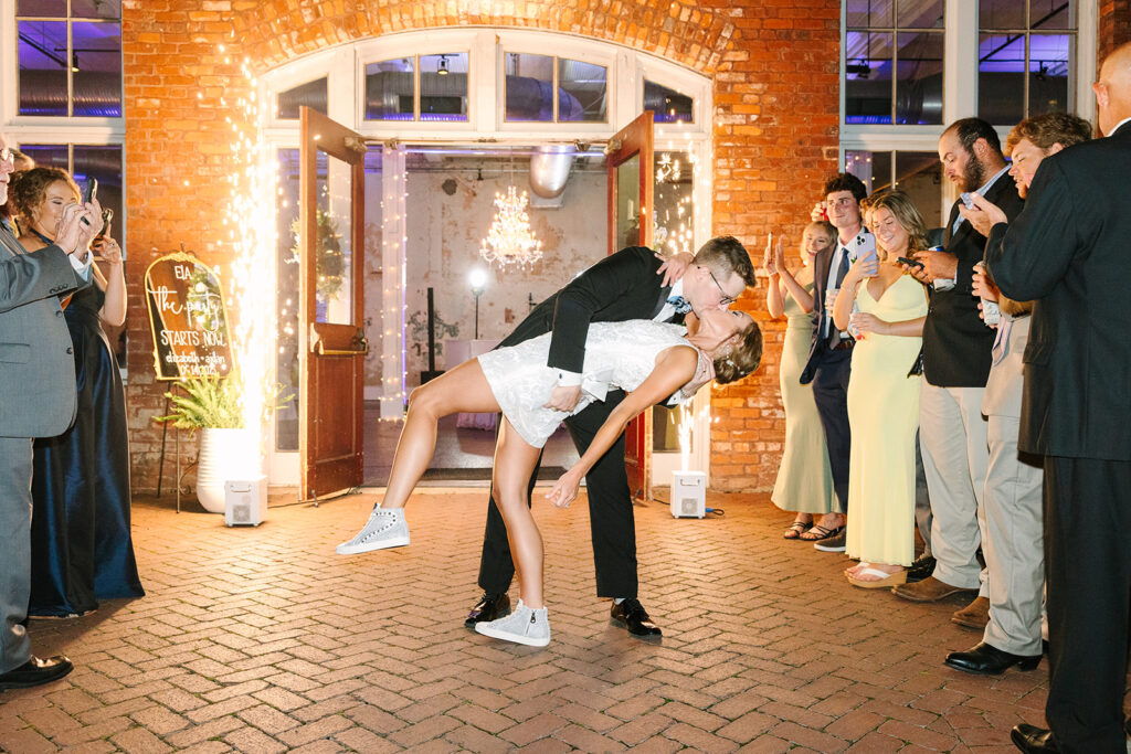 Columbia South Carolina Photographer | 701 Whaley Wedding|  bride and groom kiss in front of cold sparks outside of 701 exit.