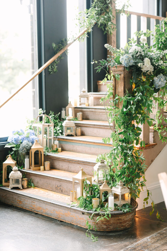 Columbia South Carolina Photographer | 701 Whaley Wedding|  greenery and candles cover the grand staircase