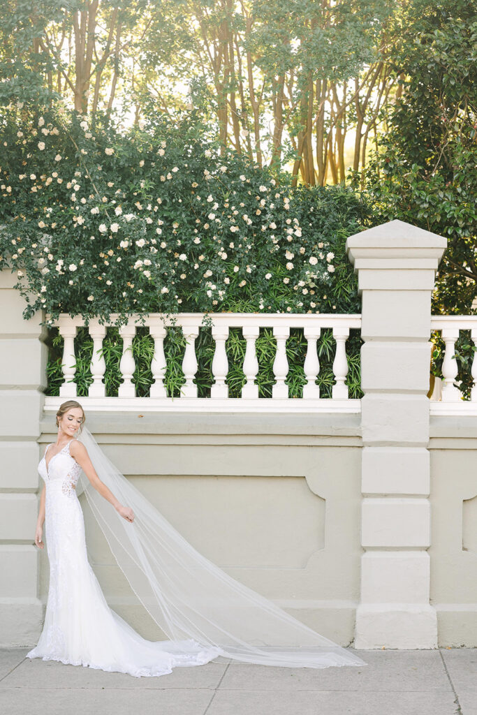 Charleston bridal portrait locations | Bride in the sunset holding veil out