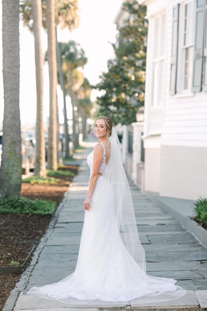bridal portraits in Charleston | bride at waterfront looking back